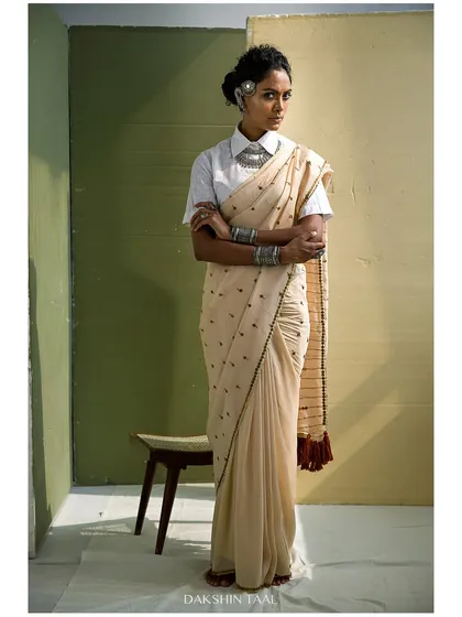 This portrait is a blend of modern styling and traditional grace. The natural light and earthy tones complement the beautiful saree, resulting in an editorial shot that feels both powerful and effortlessly elegant.