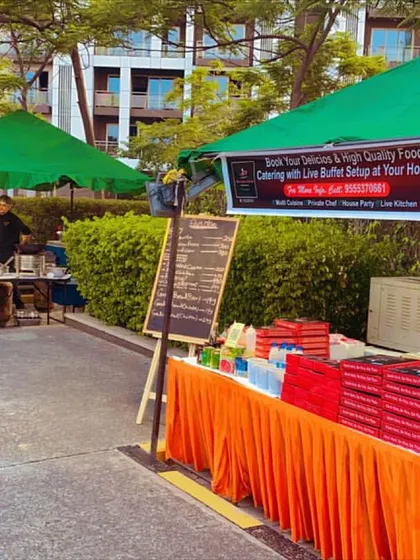 Here is one of our live food stalls at an outdoor event in Tata Premanti, Gurgaon. We provide a complete, professional setup with canopies and tables for any location, ensuring a seamless catering experience.