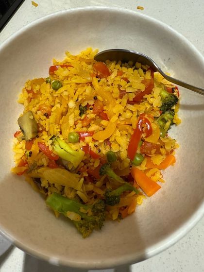 A colorful bowl of vegetable fried rice, packed with broccoli, bell peppers, and peas. A healthy twist on a popular dish.