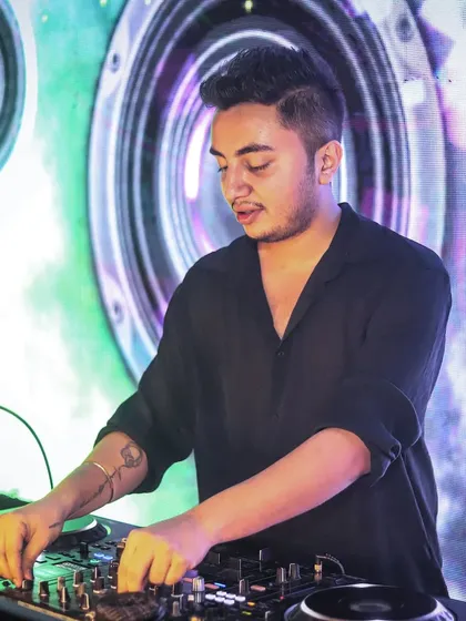 In the zone, focused on the mix. Behind the energy and crowd interaction is the technical skill of blending tracks seamlessly to keep the party flowing without a single dull moment.