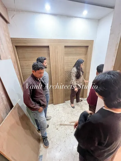 Exploring the interior details during a site visit. I am here with my team, discussing the woodwork and ensuring functionality in every corner.