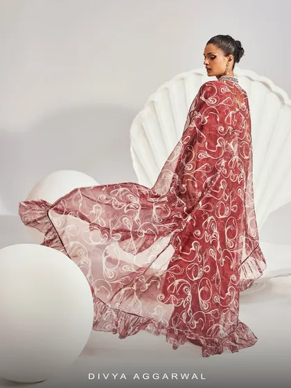 The back view of the Serena Saree Set, showcasing the sheer beauty and dramatic length of the printed ruffle cape.