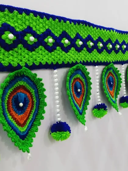 I love making these peacock feather or 'Mor Pankh' torans. The rich blues and greens, combined with delicate pearl beads, create a vibrant and elegant look for any main door or pooja room entrance.