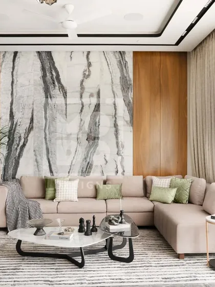 This living room design features a neutral L-shaped sofa set against a striking marble and wood-paneled wall. The striped area rug and layered coffee tables add texture and interest, creating a space that is both calm and sophisticated.