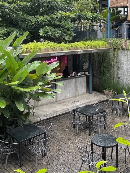 The courtyard of the IRIS Cafe, designed as a green sanctuary in the city. By preserving existing trees and adding dense foliage, I created an open-air experience where patrons can connect and unwind surrounded by nature.