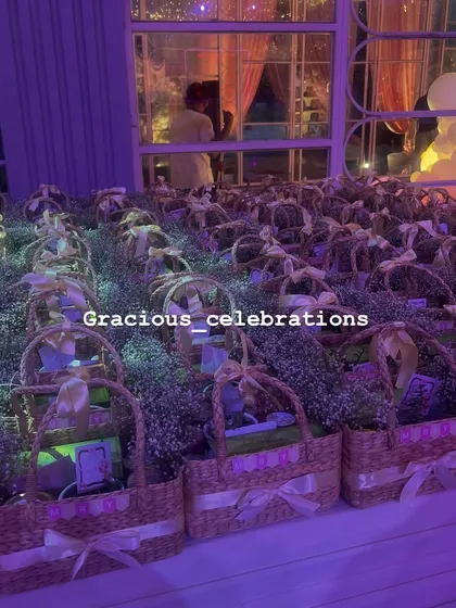 The return favor baskets displayed at the first birthday party venue. We coordinated the colors and fresh flower decorations to match the party's decor perfectly.