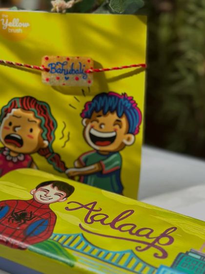 Another fun Rakhi combo, pairing a Spiderman-themed pencil box with a 'Bahubali' Rakhi.