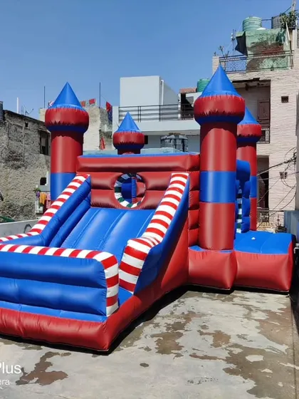 A castle-themed bouncy in red and blue with striped accents. This patriotic color scheme is a popular custom request.