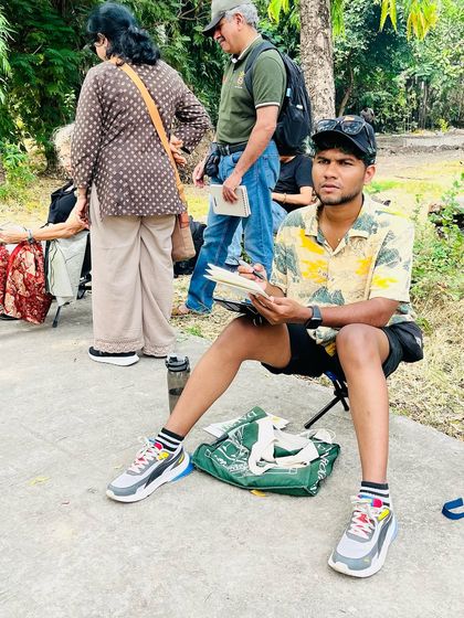A candid shot of me sitting and sketching during the Nagpur sketchwalk, completely absorbed in the process.