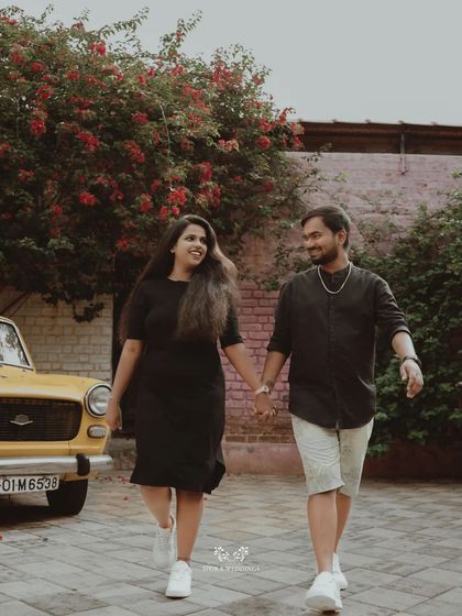The couple walking hand-in-hand away from a vintage yellow car, a perfect blend of classic and modern styles.