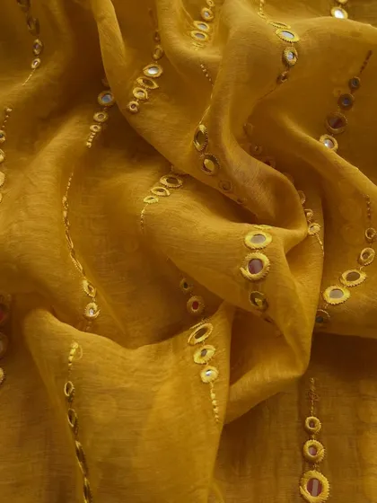 Another look at our mirror-work Mul Chanderi in mustard yellow, showing how the fabric catches the light to create a celebratory sparkle.