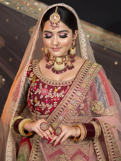 A demure pose showing off the soft, blended eyeshadow and the beautiful details of the bridal jewelry.