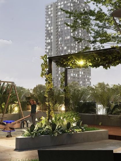 The children's play area at Kailash Apartments is nestled among lush greenery and under a vine-covered pergola. This biophilic design approach creates a safe and inspiring environment for play, connecting children with nature in an urban setting.