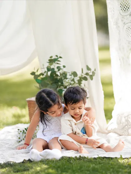 A quiet, sweet moment between a sister and her younger brother during their family's outdoor photoshoot. Capturing sibling bonds is so important.