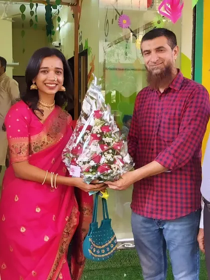 Gratefully accepting a bouquet from a well-wisher. The support from our community on opening day was truly overwhelming and encouraging.