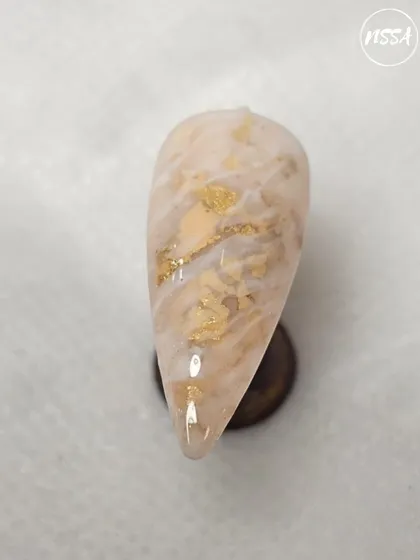 This sophisticated marble nail with gold foil accents was crafted by a student. This technique requires a good understanding of gel manipulation, which we cover in our courses.