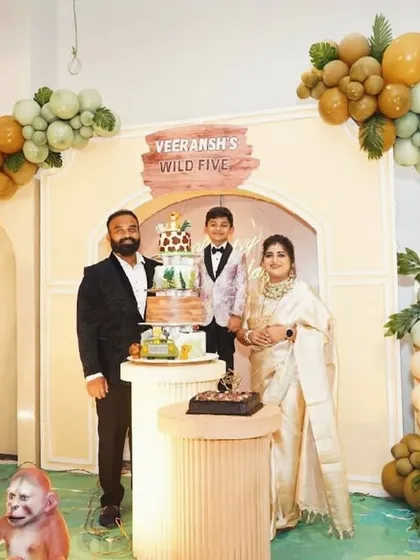 A lovely family photo capturing the joy of Veeransh's 'Wild Five' birthday party, surrounded by the immersive jungle decor.