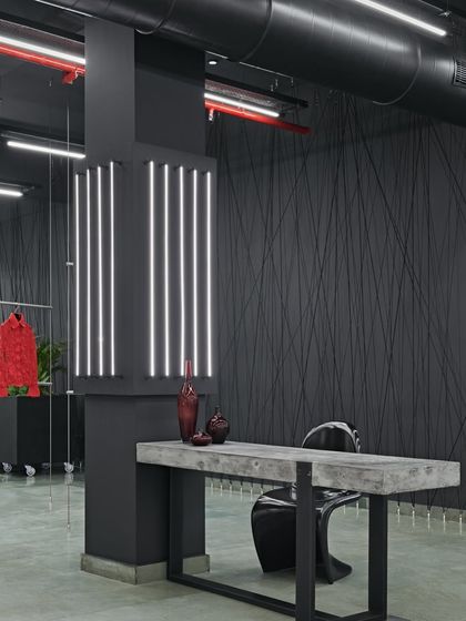A waiting area for a high-end Italian fashion design house. I used black and red hues to create a striking contrast, echoing the raw beauty of industrial elements while showcasing exquisite couture.