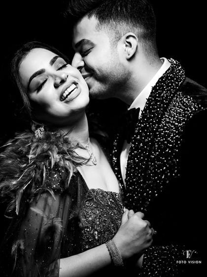 A joyful, candid moment captured in stunning black and white. The groom whispers to his bride, eliciting a beautiful, natural smile. These are the unscripted moments we live for.