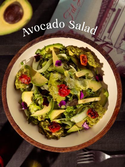 A vibrant and healthy Avocado Salad, packed with fresh greens, creamy avocado, and cherry tomatoes. It's a light and refreshing option to start your meal.