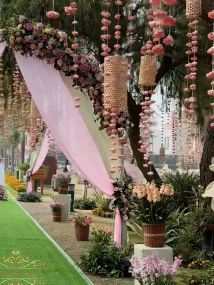 A closer look at the draped entrance, showing the delicate sola flower and cane basket hangings.