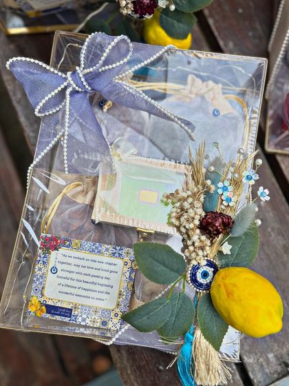 A beautifully composed gift box from the Moroccan collection. The sheer blue ribbon, dried floral arrangement, and thematic card come together to create a gift that is both visually stunning and full of meaning.