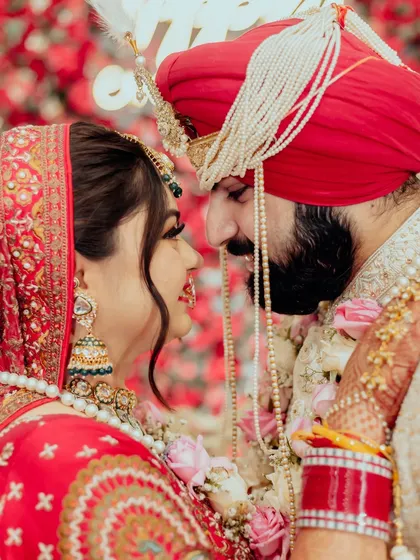 In the quiet moments before the world sees you as one, we find the purest expressions of love. This intimate close-up captures the unspoken promises and deep affection between a bride and groom, their faces close, lost in their own world.