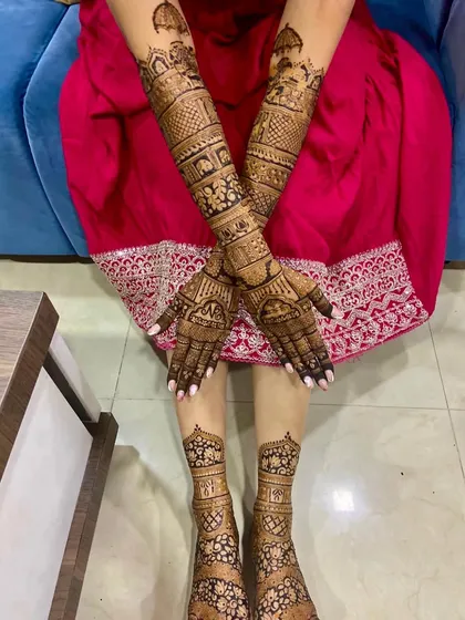 The complete bridal look. Here you can see the intricate mehendi on both hands and feet, designed to create a cohesive and stunning look for my beautiful bride, Nidhi.