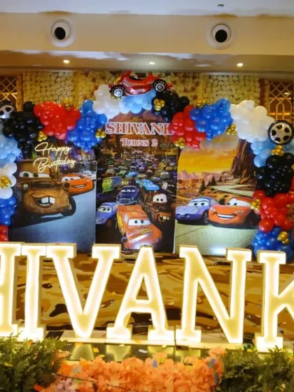 The main backdrop with large, illuminated marquee letters spelling out the birthday boy's name.