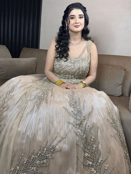A beautiful seated portrait. The makeup is soft and glowing, perfect for the evening's celebrations.