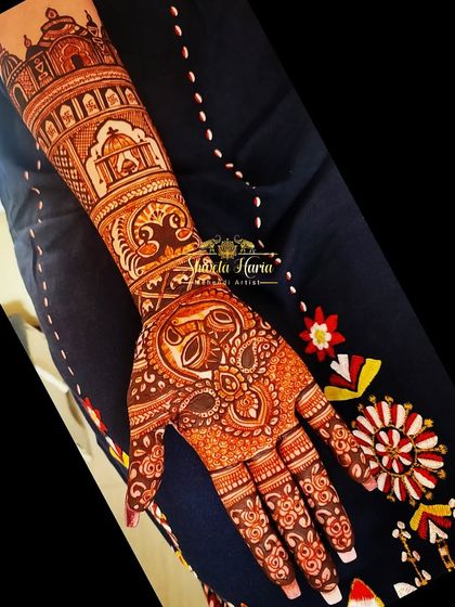 A single-arm view of the minimal bridal mehendi, showing the clean lines and thoughtful placement of each traditional element.