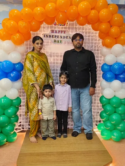 A family poses for a picture in front of our custom Independence Day photo booth. We provide beautiful, themed backdrops so you can capture precious memories during our festive events.