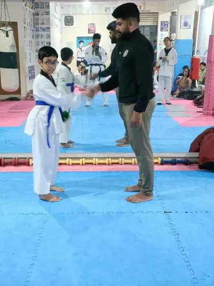 A handshake for a student who has earned his new belt.