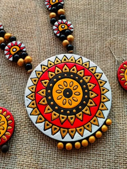 The same 'haram' style necklace, here in a vibrant red, white, and yellow color combination.