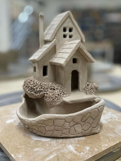 Another wonderful creation from our sculpting class. This miniature house, complete with a stone-textured base, is a testament to the creativity of our students.