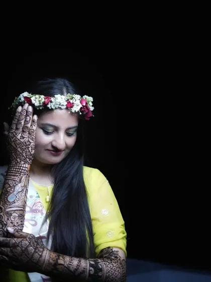 Another artistic shot focusing on the bride's intricate mehendi. The use of negative space and focused lighting creates a simple yet powerful bridal portrait.
