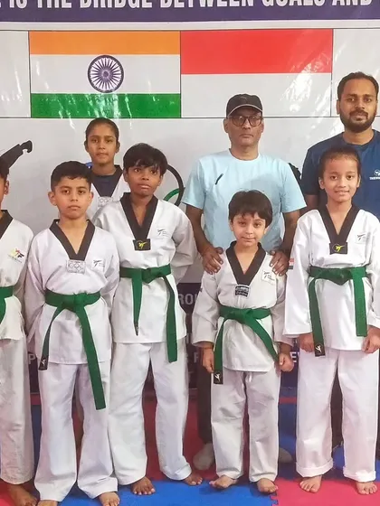 Our newly promoted green belts with their coaches. The green belt signifies a deeper understanding of Taekwondo fundamentals.