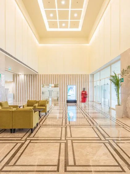 A different perspective of the Fortis Healthcare lobby, showing the long, clear corridor that aids in intuitive navigation. The design uses space and light to create a calming journey through the facility.
