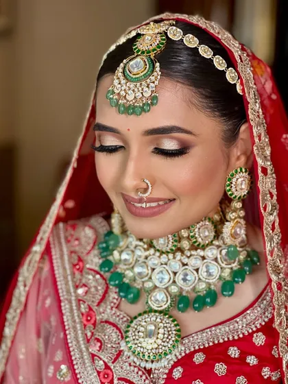 A close-up on the eyes. This shot showcases the soft, shimmery eyeshadow and the beautiful emerald tones in her jewelry, creating a look of understated elegance.