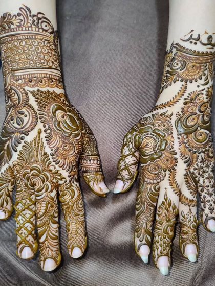 An elegant semi-bridal design with a mix of Arabic and Indian styles. One hand features a name in calligraphy.