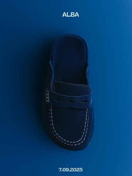 Announcing the Alba mule in a deep, versatile navy. This product shot captures the clean lines and classic loafer-inspired design of the shoe, a perfect staple for any wardrobe.
