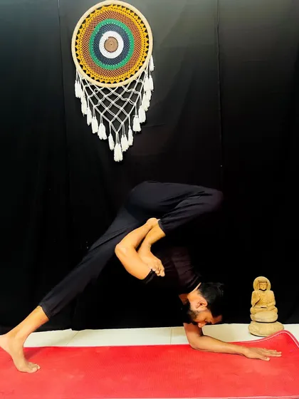 A variation of Dolphin Pose that provides a deep hip and shoulder opening. This posture prepares the body for more advanced inversions and backbends.
