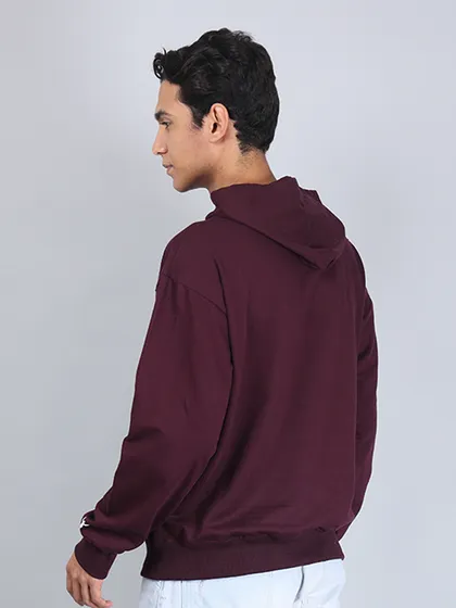 A back view of a model in a hoodie. It's crucial to show the back of a garment, especially if it has unique design features, a hood, or specific tailoring.