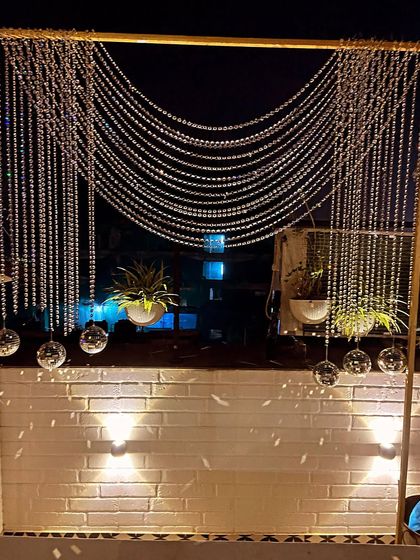 Shining bright for a 50th birthday. We created this elegant crystal curtain backdrop, accented with hanging disco balls, to add a touch of sparkle and sophistication to the evening's celebrations.