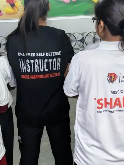 A Kavach female instructor guiding young participants during the Project 'Shakti' women empowerment program.