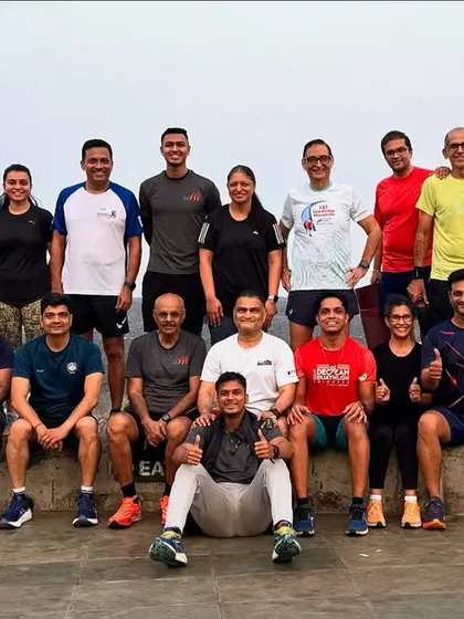 Raindrops are like nature's confetti for our running squad. A group photo after a refreshing run in the rain.