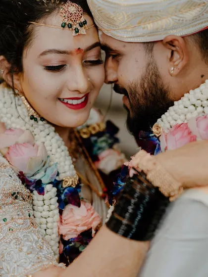 A tight, emotional close-up of a South Indian couple during their wedding ceremony, sharing a moment of pure joy. Capturing these candid, heartfelt interactions is a cornerstone of our documentary approach.