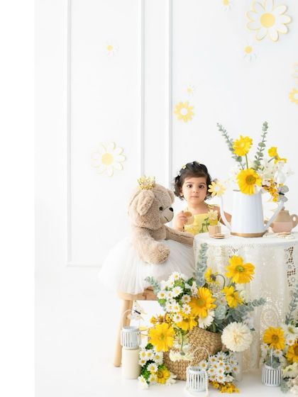 A close up of the little miss sunshine enjoying her tea party. The details, from the teddy bear's tutu to the flowers in the teapot, all add to the magical story.