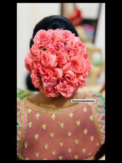 Another view of the beautiful rose bun, showing how it perfectly complements the client's embellished blouse for her reception.
