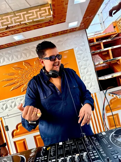The energy is building. You can see the passion in my expression as I get lost in the music, ensuring the vibe is just right for the celebration.
